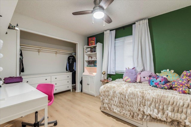 8614 Croydon Loop, Austin, TX 78748 - bedroom featuring light wood finished floors, a closet, a textured ceiling, and ceiling fan