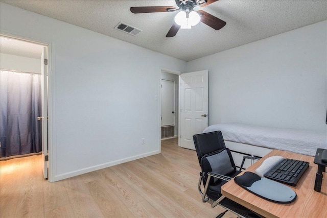8614 Croydon Loop, Austin, TX 78748 - home office featuring light wood-style flooring, ceiling fan, and a textured ceiling