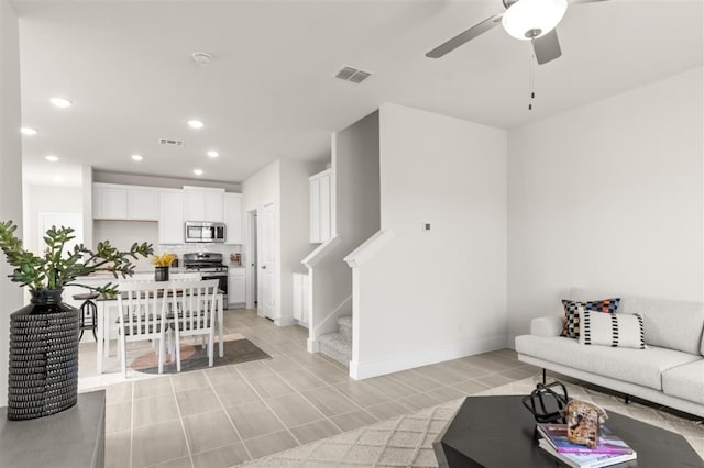 living room with recessed lighting, a ceiling fan, stairway, and baseboards