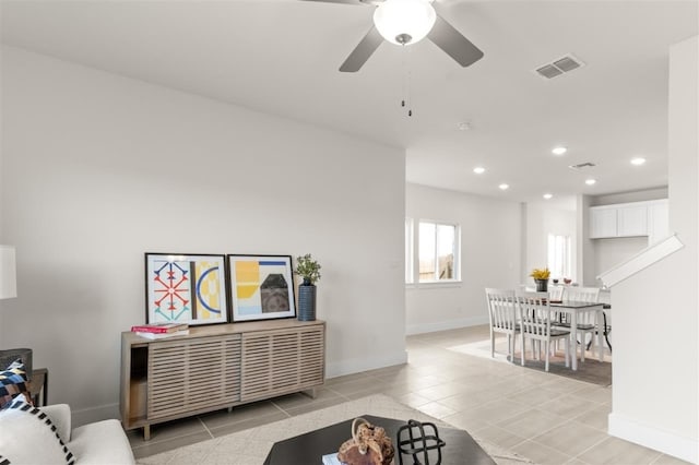 living room with light tile patterned flooring, recessed lighting, baseboards, and a ceiling fan