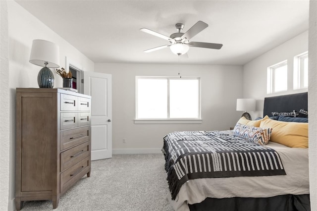 bedroom with light carpet, baseboards, and ceiling fan