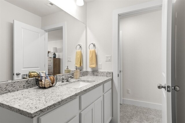 bathroom featuring vanity and baseboards