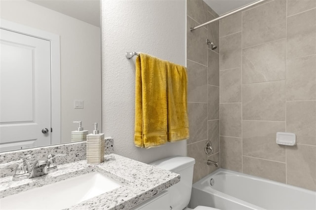 bathroom with vanity, washtub / shower combination, and toilet