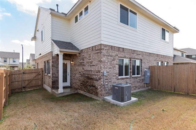 rear view of house with brick siding and central AC unit