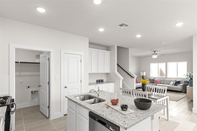 kitchen featuring a sink, gas stove, stainless steel dishwasher, white cabinetry, and a ceiling fan