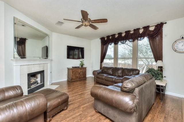 2435 Candle Ridge Trl, Georgetown, TX 78626 - living area featuring a ceiling fan, wood finished floors, a fireplace, and visible vents