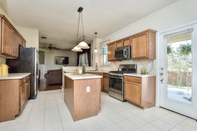 2435 Candle Ridge Trl, Georgetown, TX 78626 - kitchen with open floor plan, decorative backsplash, a sink, a peninsula, and appliances with stainless steel finishes