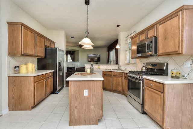 2435 Candle Ridge Trl, Georgetown, TX 78626 - kitchen with light tile patterned flooring, light countertops, stainless steel appliances, and a peninsula