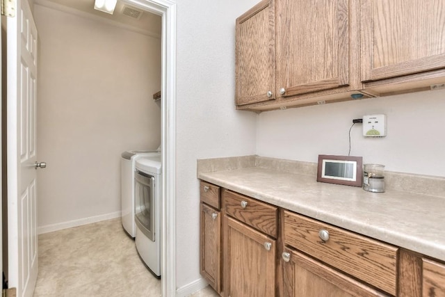 2435 Candle Ridge Trl, Georgetown, TX 78626 - clothes washing area featuring washing machine and clothes dryer, cabinet space, visible vents, and baseboards
