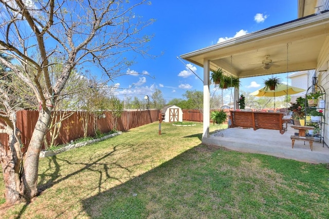 2435 Candle Ridge Trl, Georgetown, TX 78626 - view of yard featuring an outdoor structure, a fenced backyard, a patio area, ceiling fan, and a storage shed