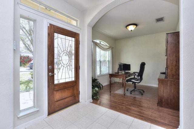 2435 Candle Ridge Trl, Georgetown, TX 78626 - entryway with light tile patterned flooring, baseboards, visible vents, and arched walkways