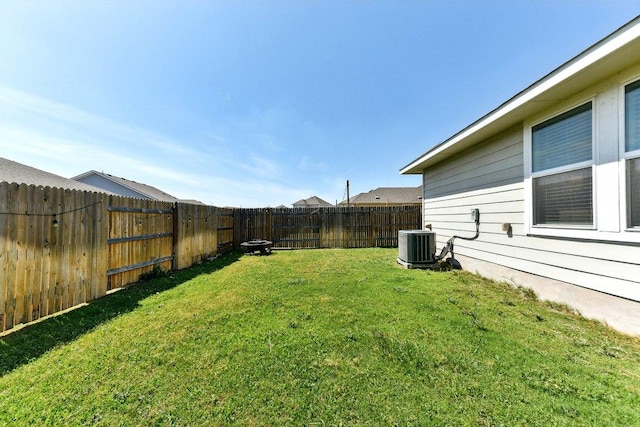 view of yard with a fenced backyard and cooling unit