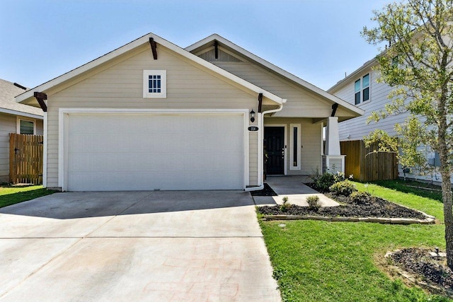 view of front of home with fence, an attached garage, concrete driveway, and a front lawn