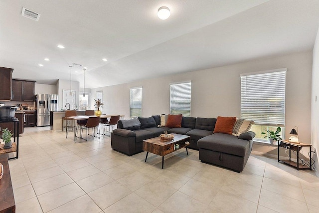 224 Trailside Ln, Bastrop, TX 78602 - living area featuring healthy amount of natural light, light tile patterned floors, lofted ceiling, and recessed lighting