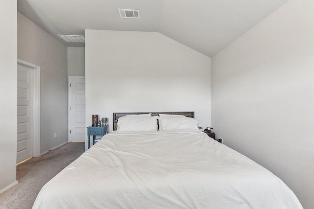 carpeted bedroom featuring baseboards, lofted ceiling, and visible vents