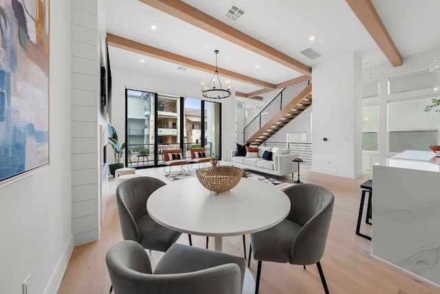 13408 Galleria Cir, Austin, TX 78738 - dining space featuring beam ceiling, light wood-type flooring, a chandelier, baseboards, and stairway
