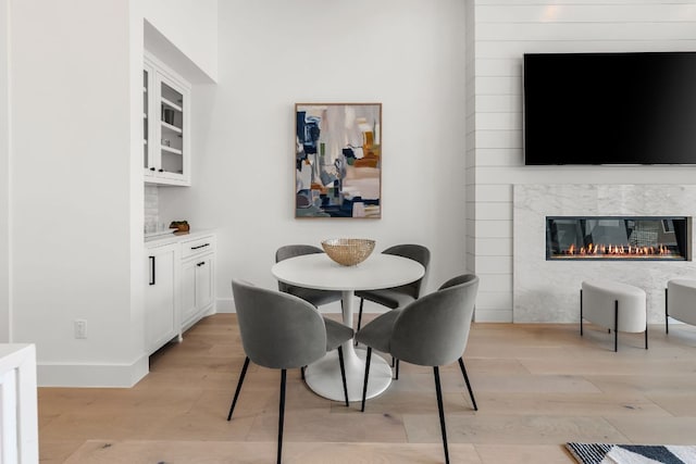 13408 Galleria Cir, Austin, TX 78738 - dining room with light wood finished floors and a fireplace