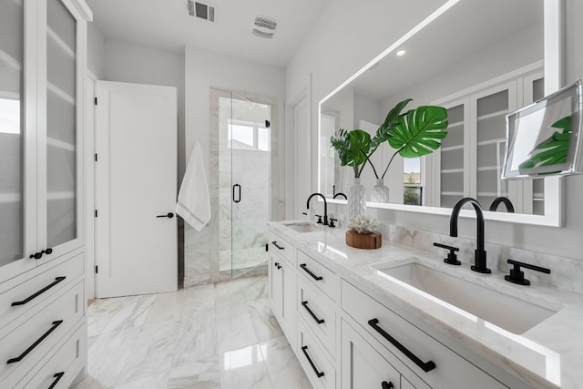 13408 Galleria Cir, Austin, TX 78738 - full bath with double vanity, a shower stall, plenty of natural light, and marble finish flooring