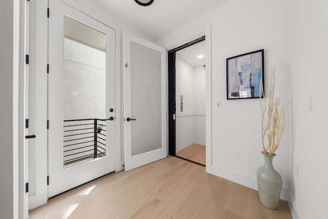 13408 Galleria Cir, Austin, TX 78738 - hall with light wood-style floors, baseboards, and french doors