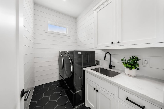 13408 Galleria Cir, Austin, TX 78738 - laundry room featuring washing machine and clothes dryer, cabinet space, dark tile patterned floors, and wood walls