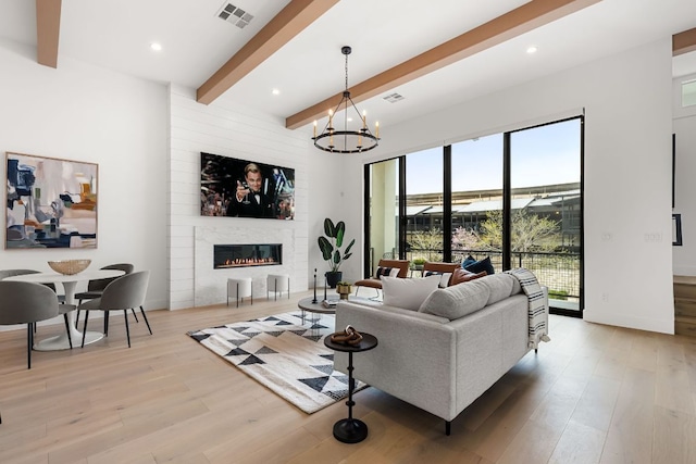 13408 Galleria Cir, Austin, TX 78738 - living area with beamed ceiling, light wood-style flooring, a fireplace, a chandelier, and recessed lighting