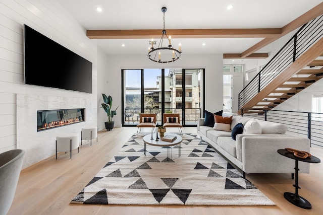 13408 Galleria Cir, Austin, TX 78738 - living area featuring light wood-style flooring, a fireplace, a chandelier, beam ceiling, and stairway