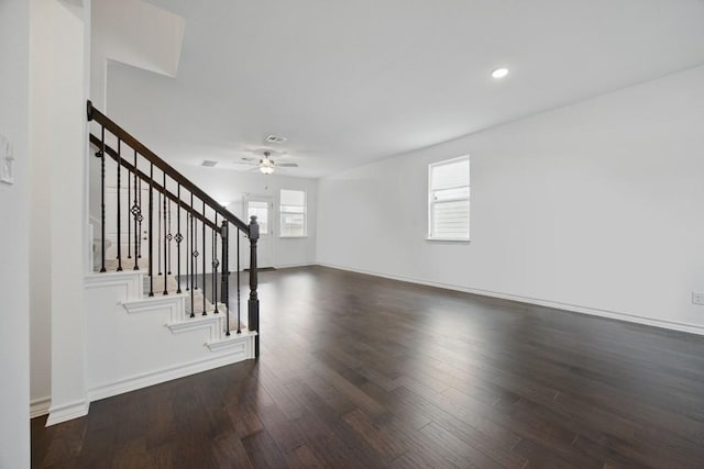 403 Stinchcomb Rd, Hutto, TX 78634 - unfurnished living room with wood finished floors, ceiling fan, stairs, and recessed lighting