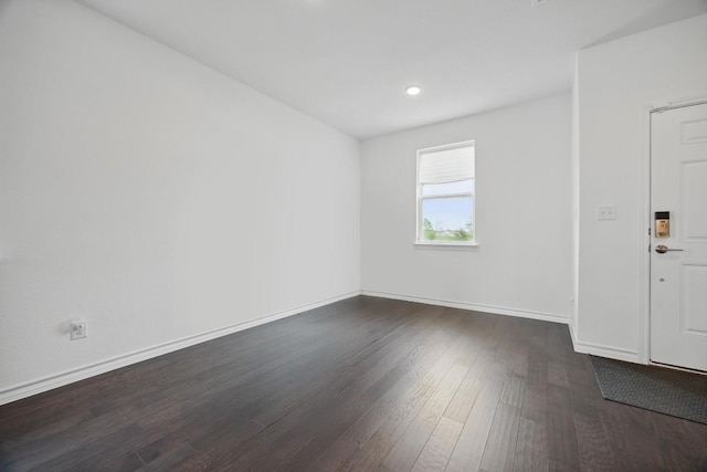 403 Stinchcomb Rd, Hutto, TX 78634 - empty room with dark wood finished floors and recessed lighting