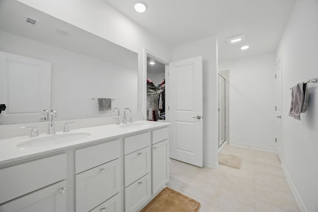 403 Stinchcomb Rd, Hutto, TX 78634 - full bathroom with a shower stall, double vanity, and a walk in closet
