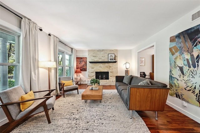 living room featuring wood finished floors and a brick fireplace