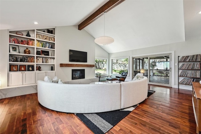 living room featuring a glass covered fireplace, hardwood / wood-style flooring, and recessed lighting