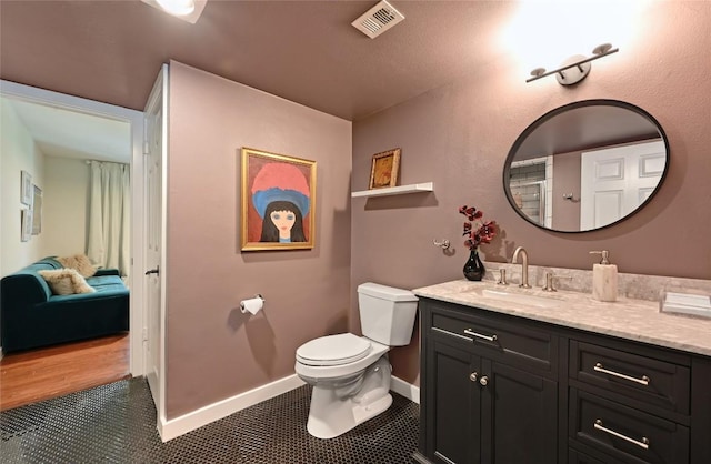ensuite bathroom featuring toilet and vanity