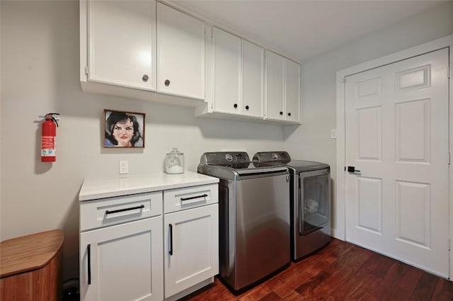 clothes washing area with cabinet space, independent washer and dryer, and dark wood-style flooring