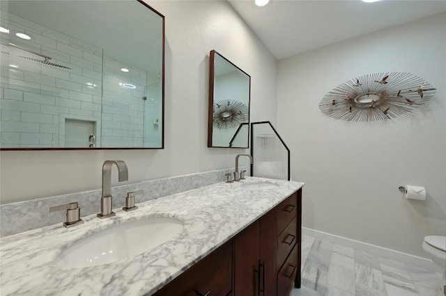 bathroom featuring double vanity, recessed lighting, tiled shower, baseboards, and toilet
