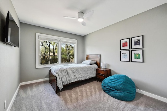 carpeted bedroom featuring baseboards and ceiling fan