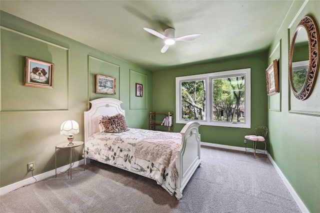 carpeted bedroom featuring baseboards and a ceiling fan