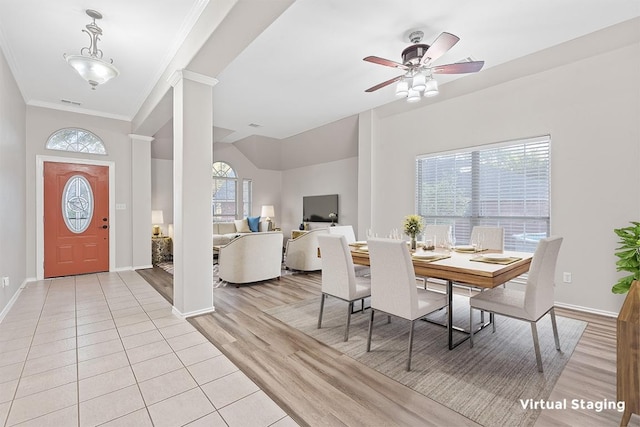 dining space with crown molding, light wood-style flooring, decorative columns, and baseboards