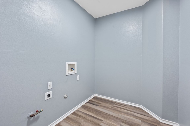 washroom featuring hookup for an electric dryer, gas dryer hookup, hookup for a washing machine, wood finished floors, and laundry area
