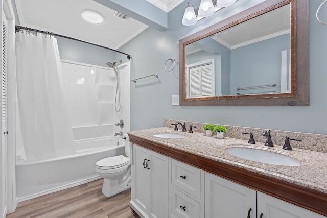 bathroom featuring ornamental molding, wood finished floors, and a sink