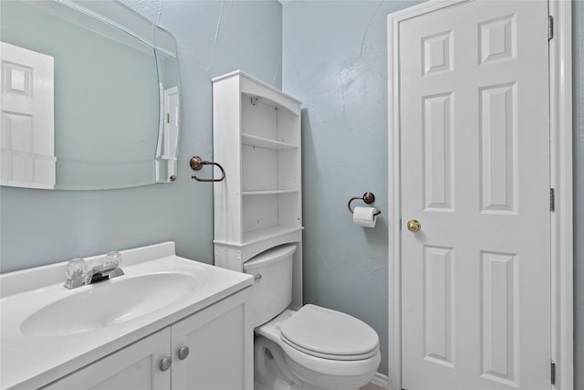 bathroom with toilet and vanity
