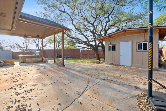 view of patio / terrace featuring a fenced backyard and an outbuilding