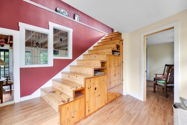 stairs with baseboards and wood finished floors