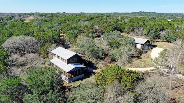 birds eye view of property featuring a wooded view
