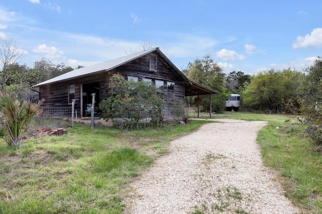 exterior space with driveway and log siding