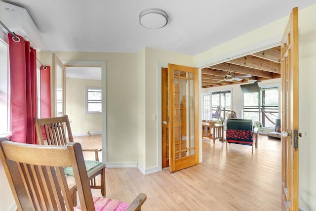 interior space featuring light wood-style flooring and baseboards