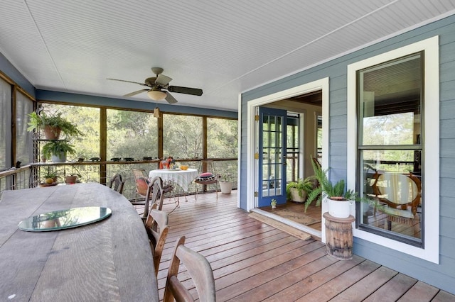 sunroom featuring ceiling fan and outdoor dining area