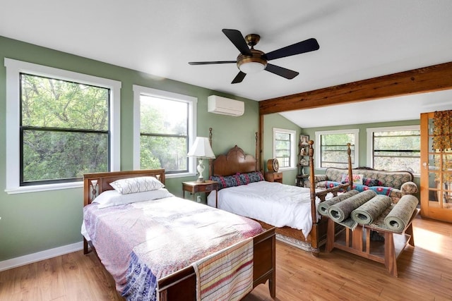 bedroom featuring lofted ceiling with beams, a wall mounted air conditioner, baseboards, light wood-type flooring, and a ceiling fan