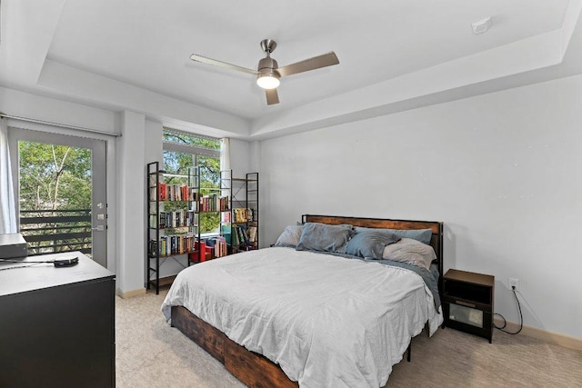 3600 S Lamar Blvd Unit 211, Austin, TX 78704 - bedroom featuring a tray ceiling, light colored carpet, access to outside, and baseboards