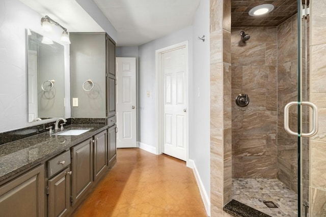 1704 W Ave Unit 108, Austin, TX 78701 - bathroom with a stall shower, baseboards, vanity, and concrete flooring