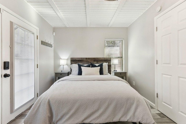 7067 Comanche Trl, Austin, TX 78732 - bedroom with light wood finished floors and beamed ceiling